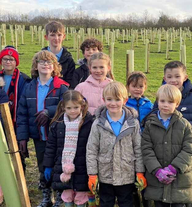 Picture of Children from St Andrews school planting trees at Weald Common