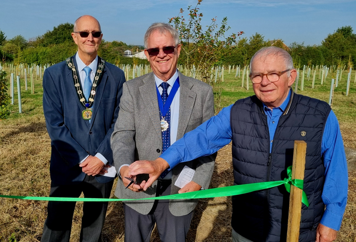 Image of Chairman cutting the ribbon for Weald Common Opening